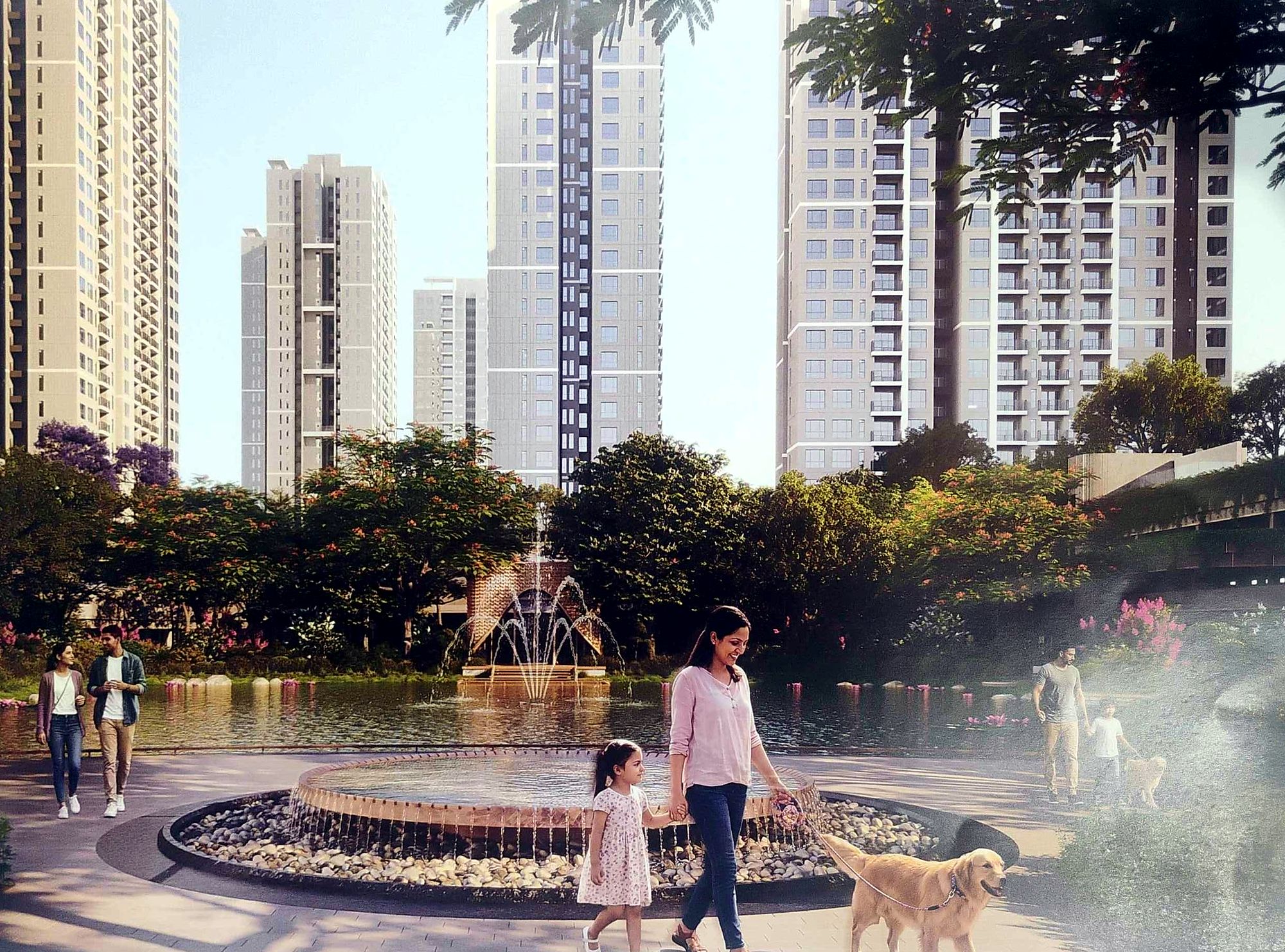 Families walking by a fountain and lake below residential towers